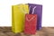 Colourful and bright shopping packages for gifts on wooden table