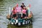 Colourful canal parade of flower and vegetables decorated boats with cheerful dressed up singing and dancing people