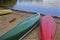 Colourful canoe lying on the beach in Lake Muskoka