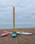 Colourful canoes on pebbly beach at Hove, East Sussex, UK. Photographed on a cold, calm winter`s day.