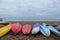 Colourful canoes on pebbly beach at Hove, East Sussex, UK. Photographed on a cold, calm winter`s day.