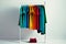 Colourful clothes on clothing rack, bright colorful closet in shopping store or bedroom. Rainbow color clothes choice on hangers,