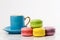 The colourful collection of French macarons, blue mug