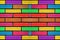 Colourful concrete brick wall pattern background with bright paibnted colours. Abstract multicolour rainbow blocks pattern