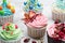 Colourful cupcakes with different modern decoration on light grey background