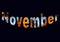 Colourful design word November font stock vector decorative element in orange and blue on black background.