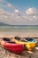 Colourful empty kayaks on the beach