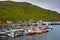 Colourful fishing boats moored at a jetty in Skarsvag harbour, Mageroya Island, Norway