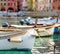 Colourful fishing boats in small marina of Vernazza, one of the five centuries-old villages of Cinque Terre, located on rugged