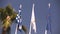 Colourful flags swaying against a blue sky, Many flags sway in the wind