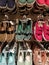 Colourful flat shoes in store display.