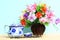 Colourful flower bunch in wood vase on wooden table and copy space