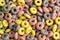 Colourful fruit cereals in a form of rings, close-up, food background