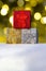 Colourful Gift boxes Presents on snow with christmas lights on the Background on a vertical view