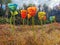 Colourful glass art flower installation on a field on a cloudy day