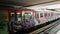 A colourful, graffiti-covered train of the subway system of Athens, Greece, arriving at the station