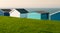 Colourful holiday wooden beach huts facing the calm ocean