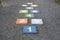 Colourful hopscotch playground markings numbers on stone at Pavement