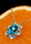 colourful jewellery pendant with gems and diamonds on orange background