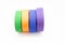 Colourful karate belt of green, yellow, purple and blue on white background