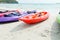 Colourful kayaks on the beach.