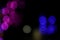 Colourful led lights bulbs in bokeh effect in black background.blurred lights effect.