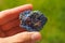 Colourful Lepidolite mineral from Brazil held in a hand