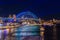 Colourful Light show at night on Sydney Harbour NSW Australia. The bridge illuminated with lasers and neon coloured lights