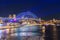 Colourful Light show at night on Sydney Harbour NSW Australia. The bridge illuminated with lasers and neon coloured lights