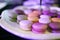 Colourful macarons dessert small cake in plate table setting