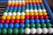 Colourful marbles of abacus on dark background