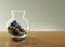 Colourful marbles in a glass jar on a table top