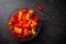 Colourful  mini bell peppers in glass bowl on dark background, top view