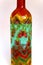 Colourful patterned hand painted glass bottle.