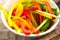 Colourful peppers sliced in white bowl