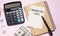 colourful pie chart with `Financial tips` text on paper, dice, spectacles, pen, calculator on pink table -