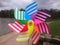 Colourful pinwheel with a park background