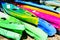 Colourful Plastic Rental Kayaks on Dry Land