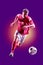 Colourful professional soccer player isolated over purple background