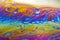 Colourful psychedelic soap bubble refractions pattern macro.