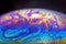 Colourful psychedelic soap bubble refractions pattern macro.