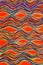 Colourful quiggly wavey lines on an orange background.