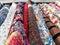 Colourful rolls of printed floral fabric arranged in a shop