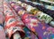 Colourful rolls of printed floral fabric displayed in a shop