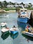 Colourful rowing boats and ferry in harbour, St Mawes, Cornwall, UK