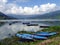 Colourful rowing boats on Phewa Lake, Pokhara, Nepal with mountains