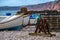 Colourful scene of a working beach with fishing boats and lobster pots at Burleigh Salterton