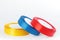 Colourful shiny satin ribbons in a rolls on a white background