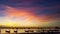 Colourful sky reflects with the sea and taxi boats along the bay