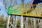 Colourful steel footbridge spiralling up in blue sky of sunny wi